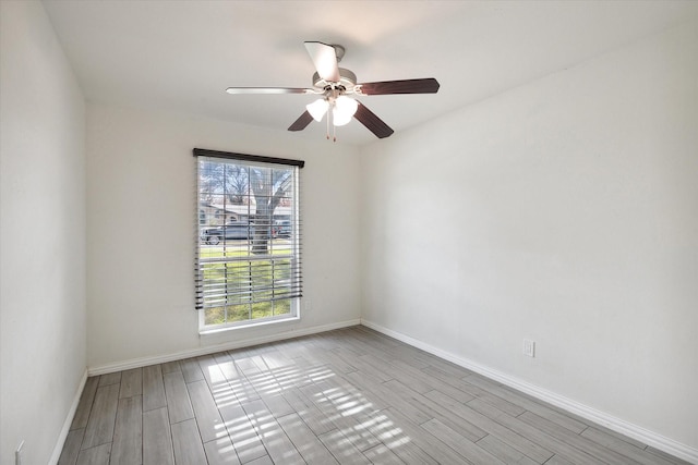 spare room featuring light hardwood / wood-style flooring and ceiling fan