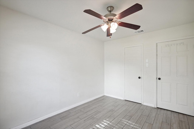 unfurnished bedroom featuring light hardwood / wood-style floors and ceiling fan