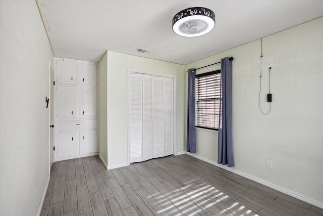 unfurnished bedroom with a closet and light wood-type flooring