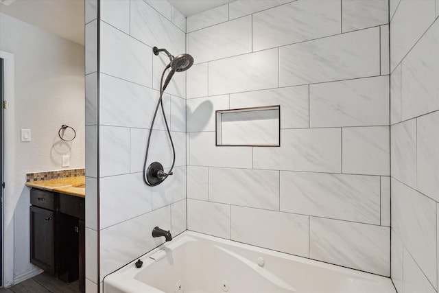 bathroom featuring vanity and tiled shower / bath combo