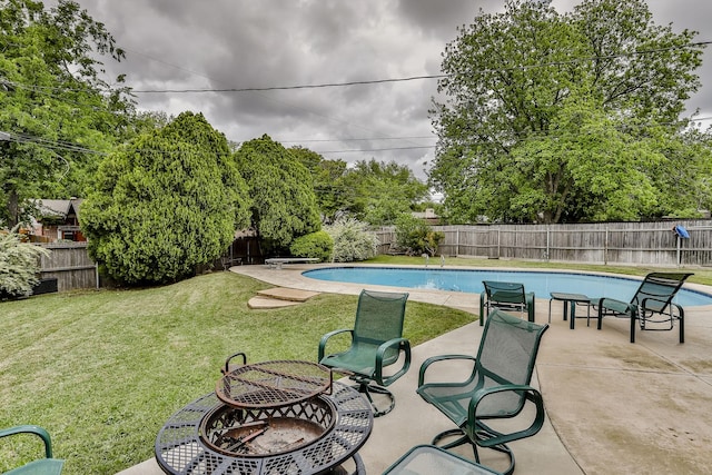 view of swimming pool with a fire pit, a lawn, and a patio