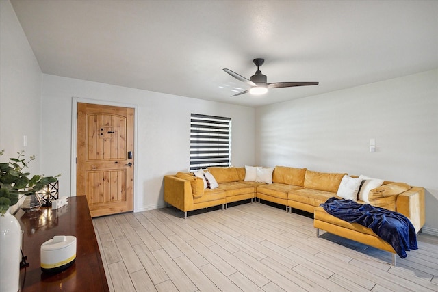 living room featuring ceiling fan and light hardwood / wood-style floors