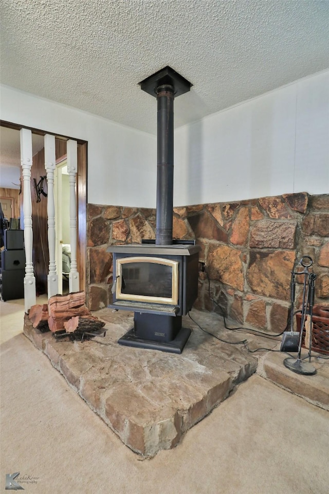 details with carpet flooring, a wood stove, and a textured ceiling