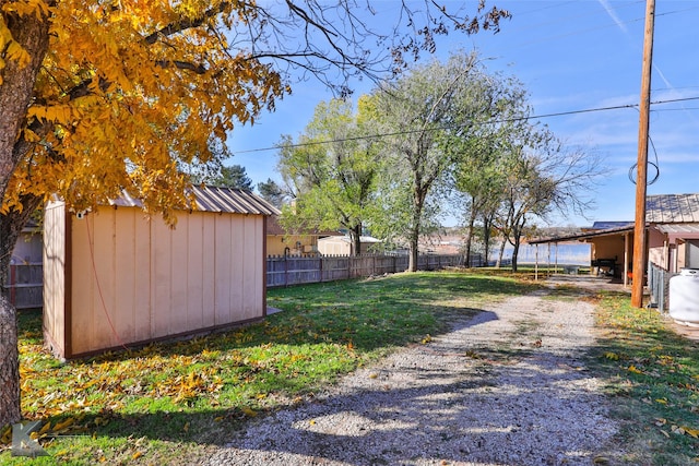 view of yard with a storage unit and a carport