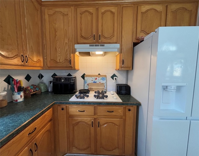 kitchen featuring white appliances and decorative backsplash