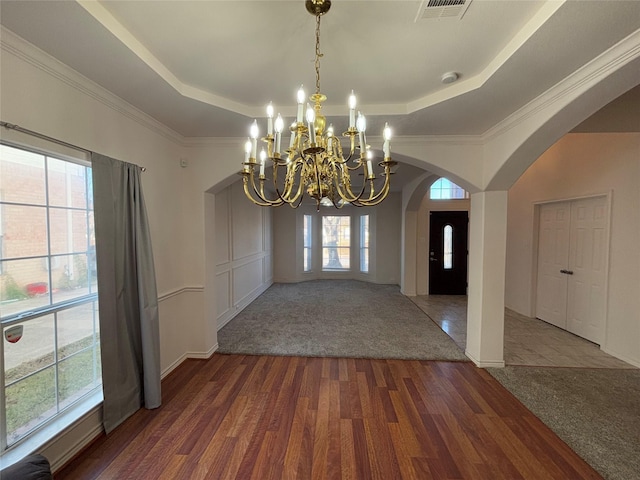 foyer entrance with dark hardwood / wood-style floors, ornamental molding, and a tray ceiling