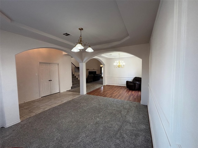 interior space featuring an inviting chandelier and a raised ceiling