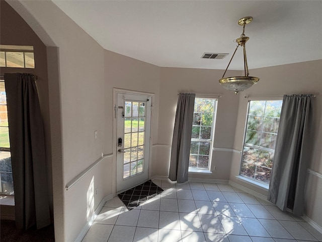 doorway to outside featuring light tile patterned flooring