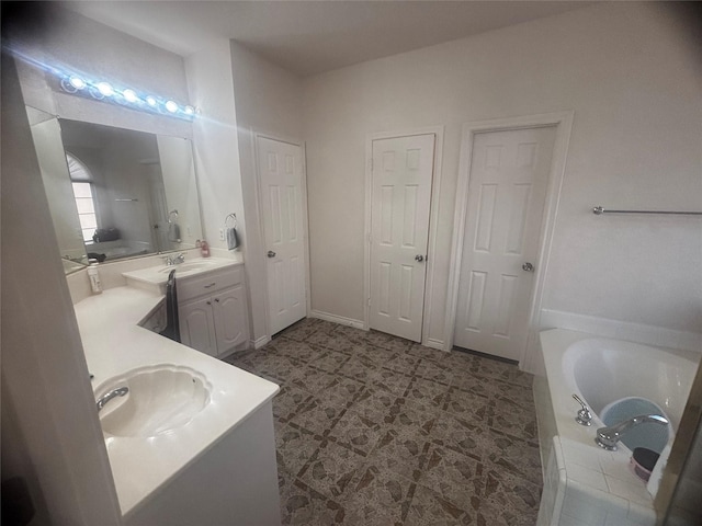 bathroom with vanity and tiled tub