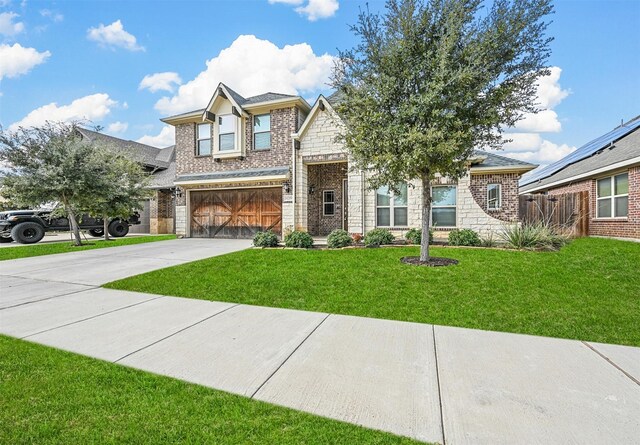 view of front of house with a garage and a front yard