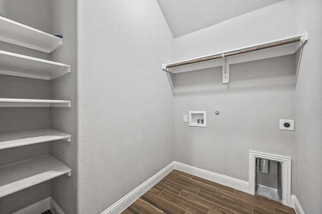 clothes washing area featuring electric dryer hookup, gas dryer hookup, washer hookup, and dark hardwood / wood-style floors