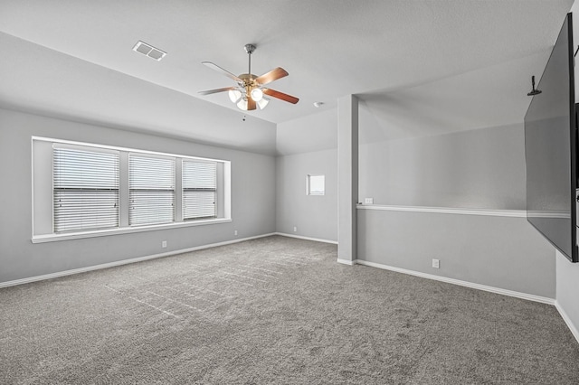 carpeted empty room with ceiling fan and lofted ceiling