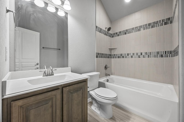 full bathroom featuring wood-type flooring, vanity, toilet, and tiled shower / bath