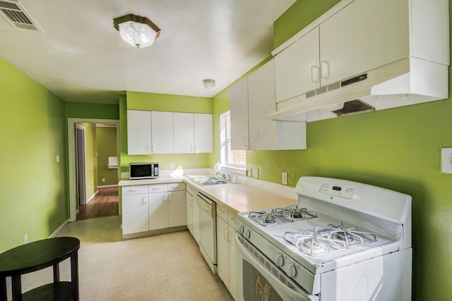 kitchen with sink, white cabinets, and white appliances