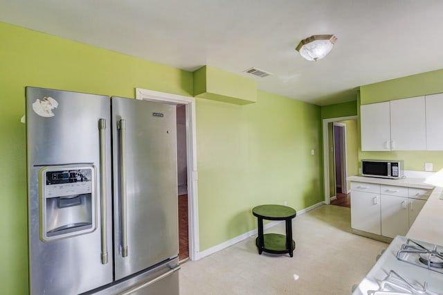 kitchen featuring white cabinetry and appliances with stainless steel finishes