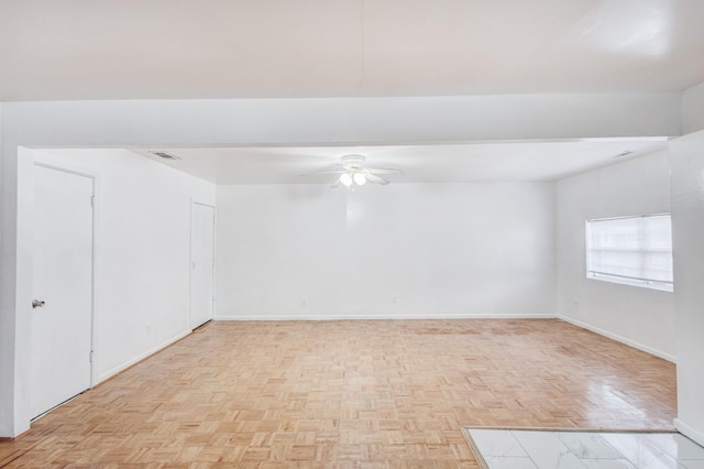 empty room featuring light parquet flooring and ceiling fan