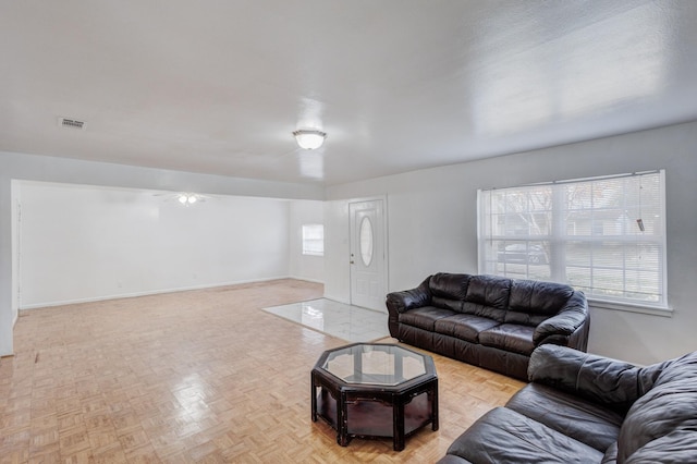 living room with light parquet floors and a healthy amount of sunlight