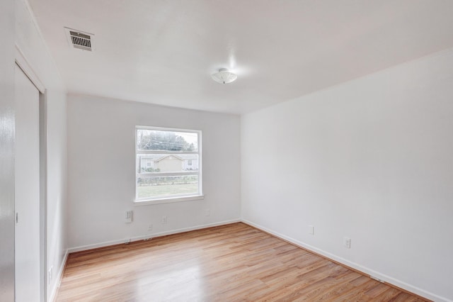 spare room featuring light hardwood / wood-style flooring