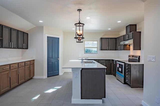 kitchen with dark brown cabinetry, a kitchen island with sink, sink, a chandelier, and stainless steel electric range oven