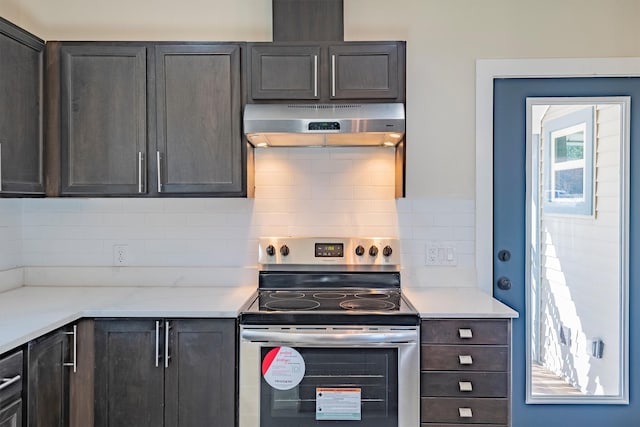 kitchen with decorative backsplash, dark brown cabinetry, and stainless steel electric range oven