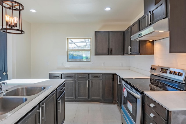 kitchen with backsplash, electric stove, sink, and hanging light fixtures