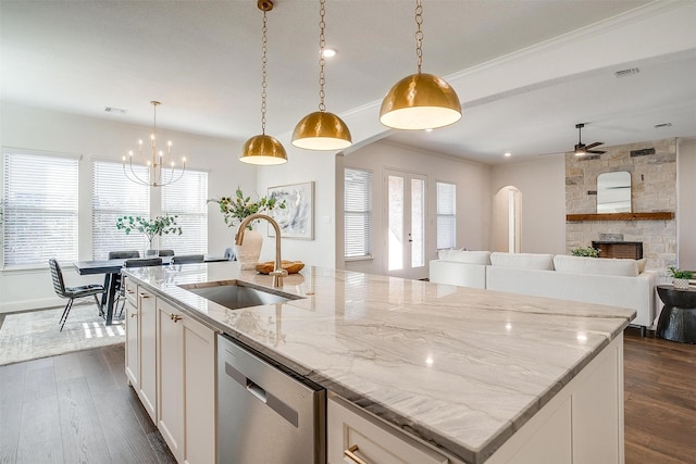 kitchen with dark wood-type flooring, sink, pendant lighting, dishwasher, and white cabinetry