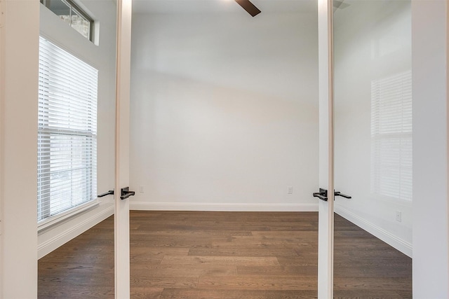 unfurnished room featuring dark hardwood / wood-style floors and french doors