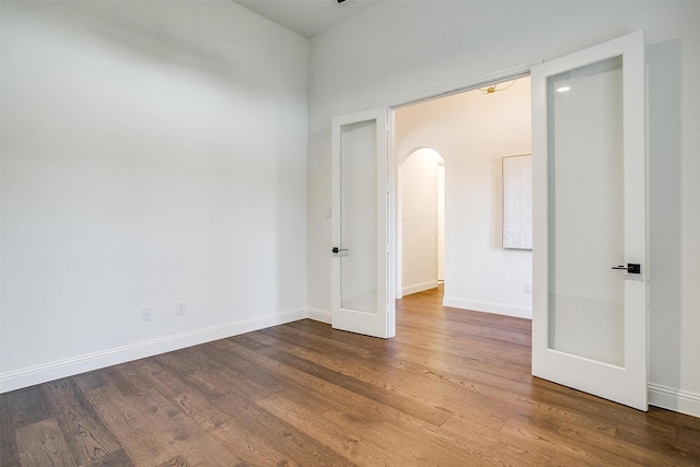 spare room with wood-type flooring and french doors