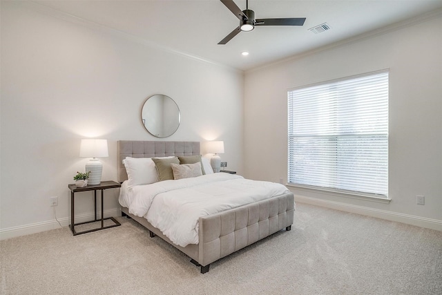 carpeted bedroom featuring ceiling fan and crown molding