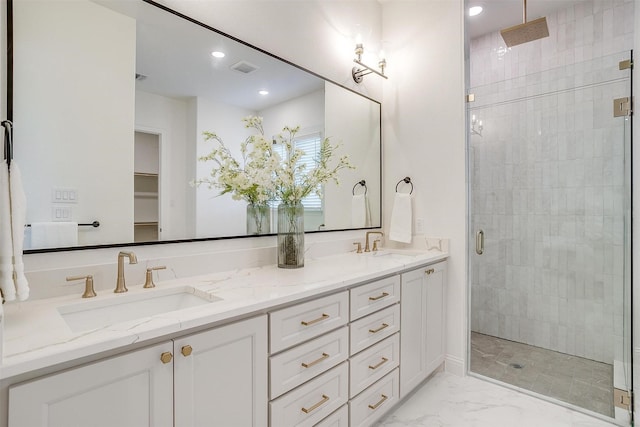 bathroom featuring vanity and an enclosed shower