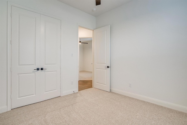 unfurnished bedroom featuring carpet floors, a closet, and ceiling fan