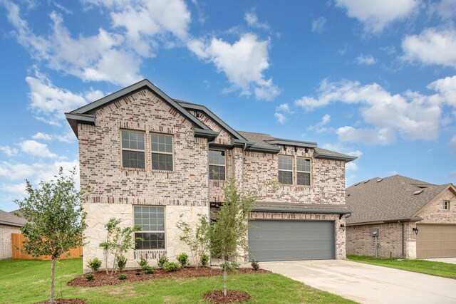 view of front of house featuring a front yard and a garage