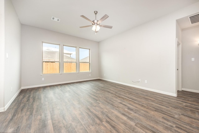 spare room featuring dark hardwood / wood-style flooring and ceiling fan