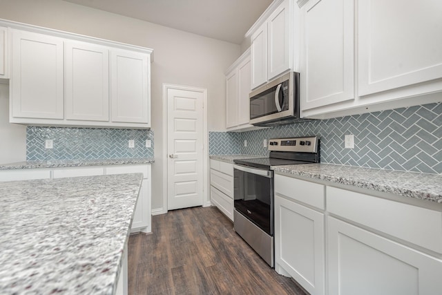 kitchen with light stone countertops, stainless steel appliances, dark hardwood / wood-style flooring, decorative backsplash, and white cabinets