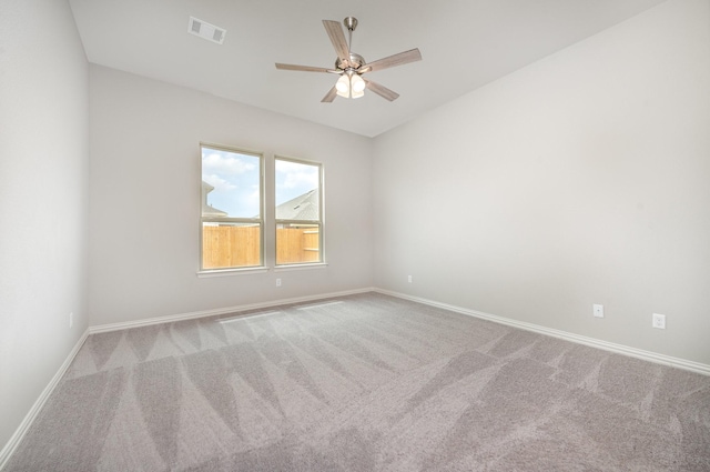 carpeted spare room featuring ceiling fan