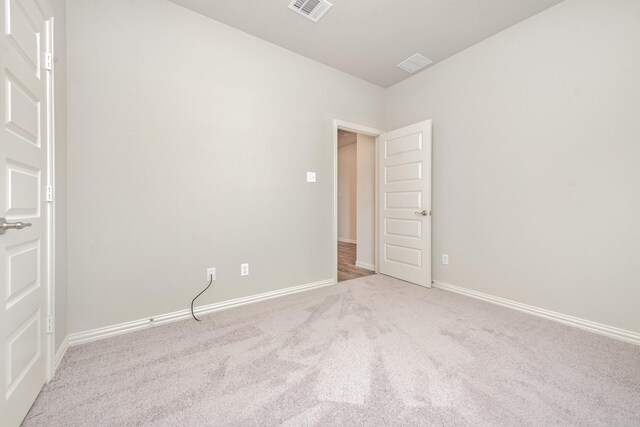 spare room with light colored carpet