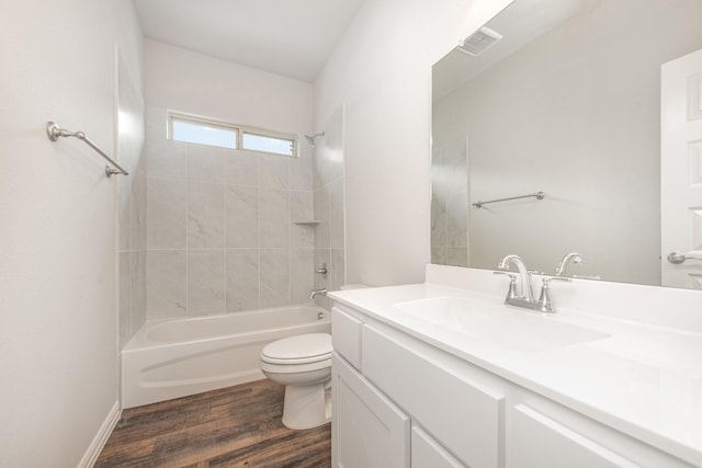 full bathroom with toilet, vanity, tiled shower / bath combo, and hardwood / wood-style flooring