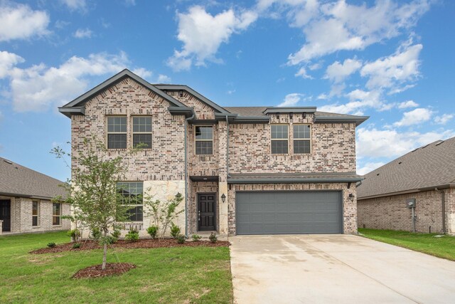 view of front of property featuring a garage and a front lawn