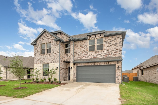 view of front of house with a garage, a front yard, and central AC