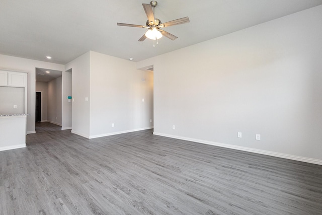 unfurnished room with ceiling fan and dark hardwood / wood-style flooring