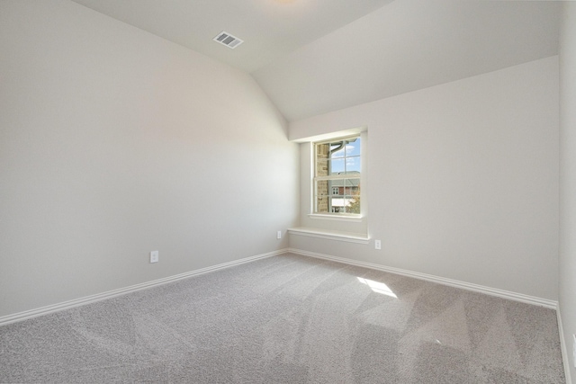 unfurnished room with carpet flooring and lofted ceiling