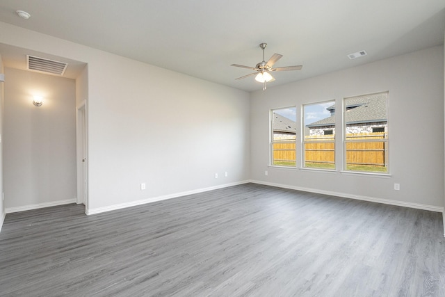 unfurnished room with dark hardwood / wood-style floors and ceiling fan