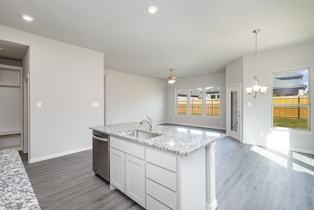 kitchen featuring hardwood / wood-style floors, dishwasher, ceiling fan with notable chandelier, sink, and white cabinetry