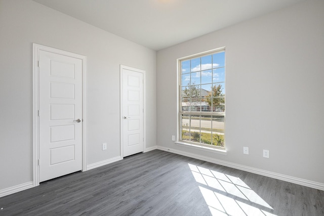 unfurnished bedroom featuring dark hardwood / wood-style floors