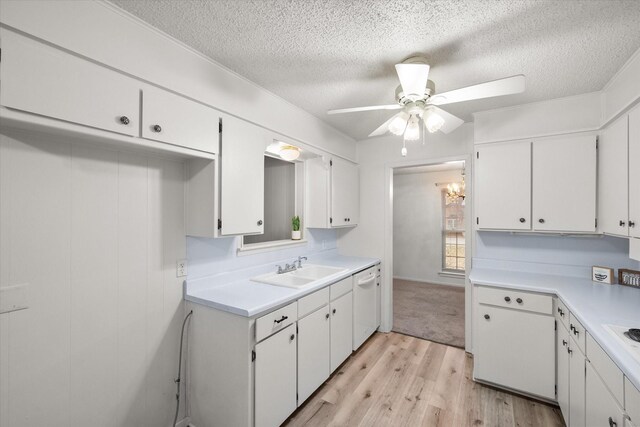 kitchen with sink, white cabinetry, white dishwasher, ceiling fan, and light hardwood / wood-style floors