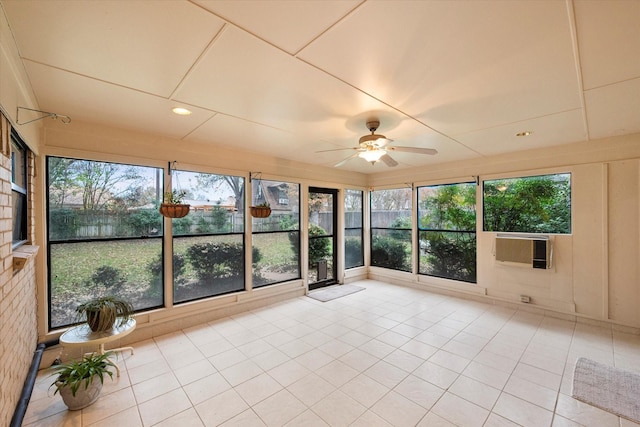 unfurnished sunroom featuring a wealth of natural light, ceiling fan, and cooling unit