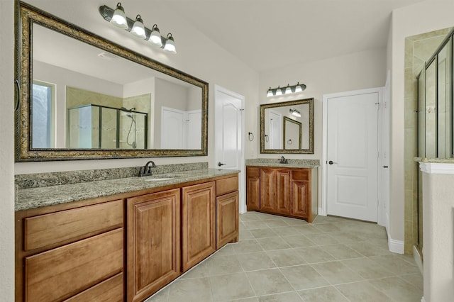 bathroom featuring an enclosed shower, vanity, and tile patterned flooring