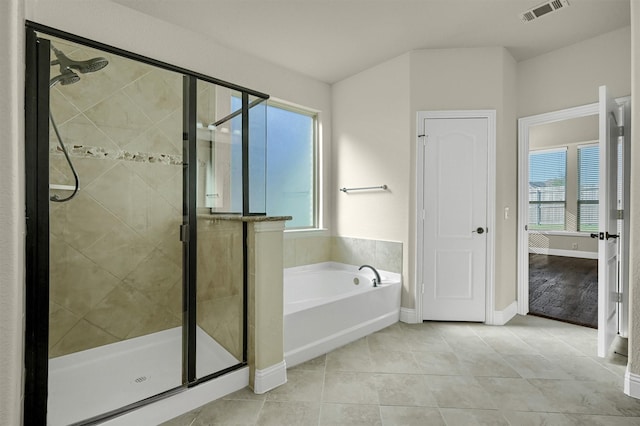 bathroom with separate shower and tub and tile patterned floors