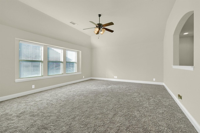 unfurnished room featuring ceiling fan, lofted ceiling, and carpet floors