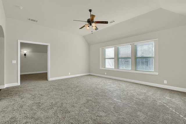 carpeted empty room with ceiling fan and vaulted ceiling